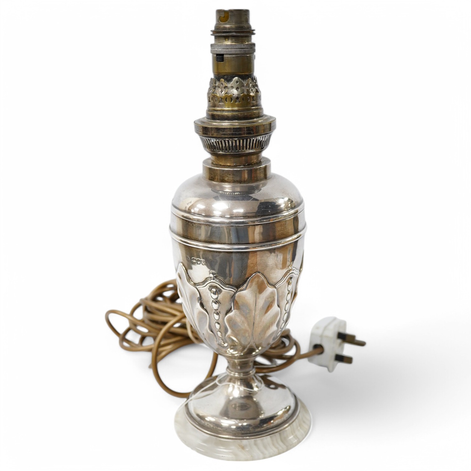 A late Victorian silver table lamp by William Hutton & Sons London, 1894, wired for electricity and later? mounted on a white onyx base, overall height 33.2cm. Condition - fair